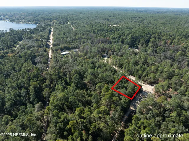 a aerial view of a houses with a yard