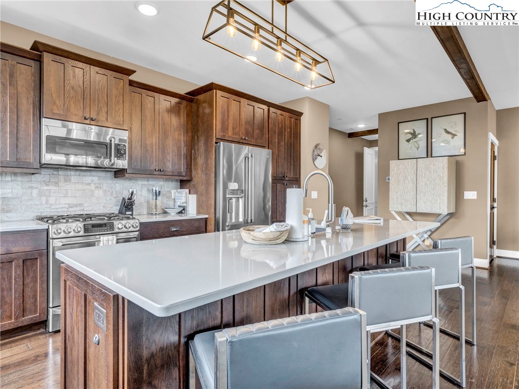 198 Ramblestone Terrace, Unit 203 Boone, NC 28607 - Photo 12 of 39 a kitchen with a sink a stove and chairs