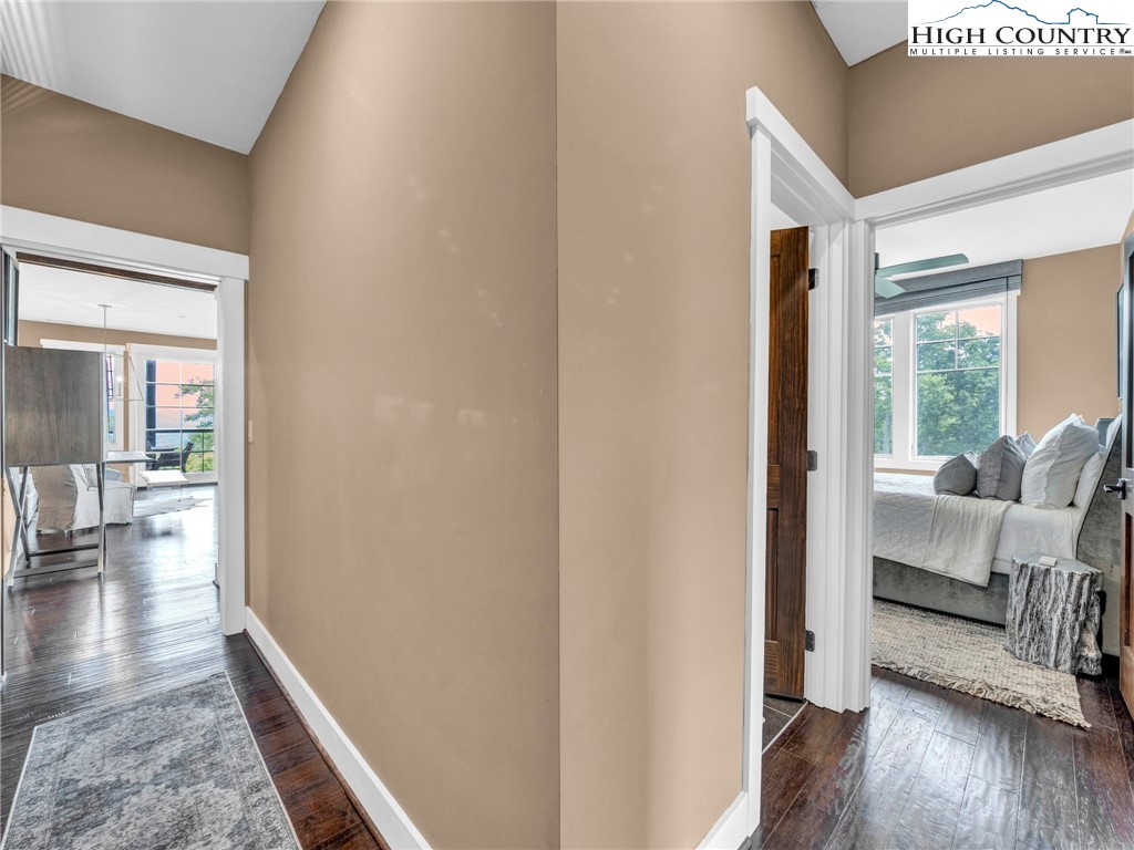 198 Ramblestone Terrace, Unit 203 Boone, NC 28607 - Photo 18 of 39 a view of a hallway with wooden floor and a bedroom