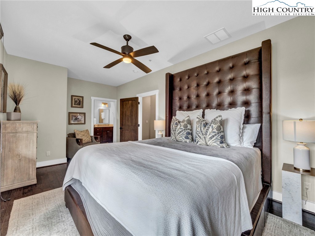 198 Ramblestone Terrace, Unit 203 Boone, NC 28607 - Photo 20 of 39 a bedroom with a large bed and a chandelier