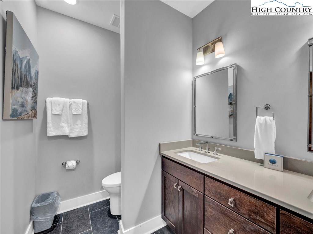 198 Ramblestone Terrace, Unit 203 Boone, NC 28607 - Photo 23 of 39 a bathroom with a double vanity sink toilet and a mirror