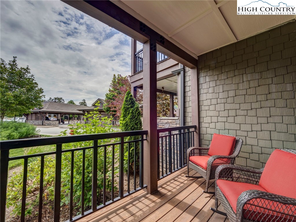 198 Ramblestone Terrace, Unit 203 Boone, NC 28607 - Photo 25 of 39 a balcony with wooden floor and outdoor seating