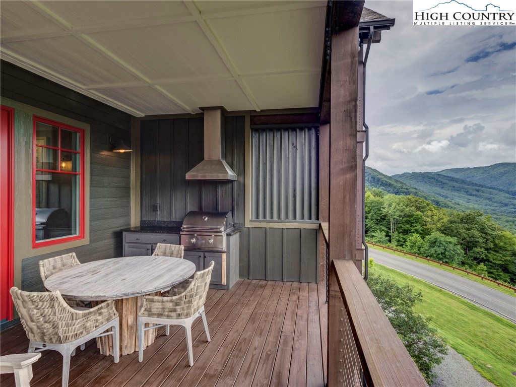 198 Ramblestone Terrace, Unit 203 Boone, NC 28607 - Photo 10 of 39 a balcony with table and chairs