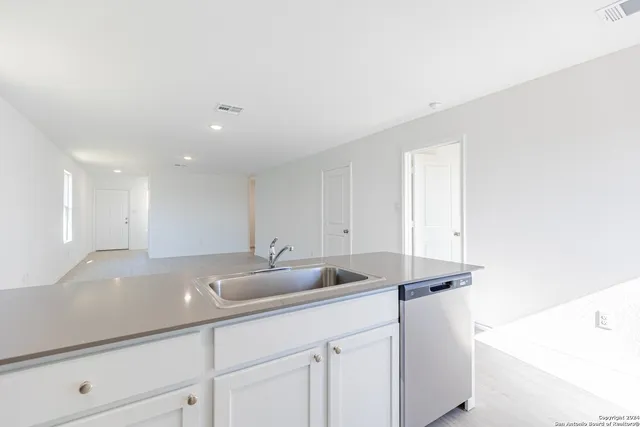 a kitchen with a sink and cabinets