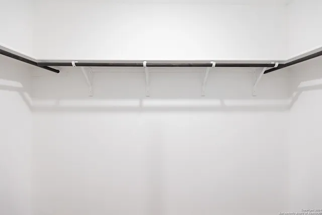 a view of a room with shelf on the wall