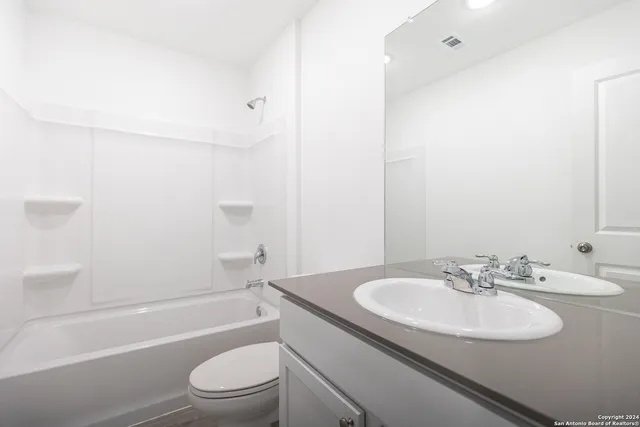 a bathroom with a sink toilet and a bathtub