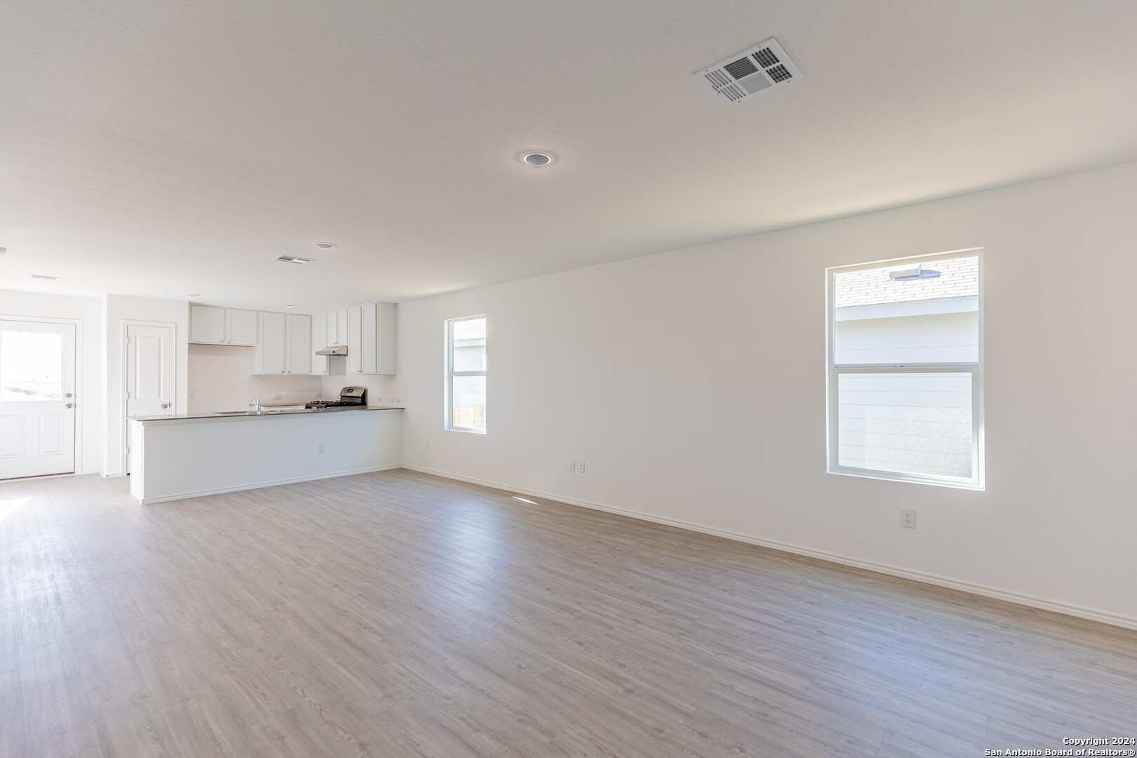 1631 Knoll Ridge New Braunfels, TX 78130 - Photo 6 of 29 a view of an empty room with wooden floor and a window