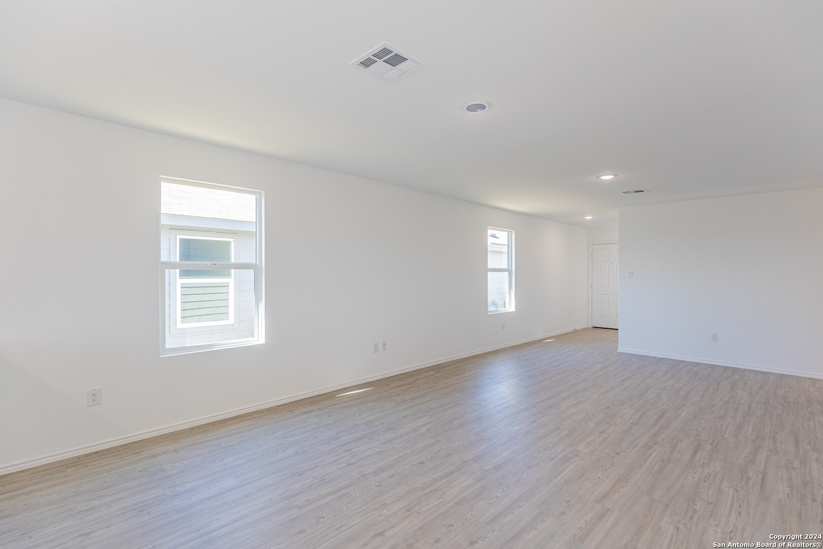 1631 Knoll Ridge New Braunfels, TX 78130 - Photo 7 of 29 an empty room with wooden floor and window