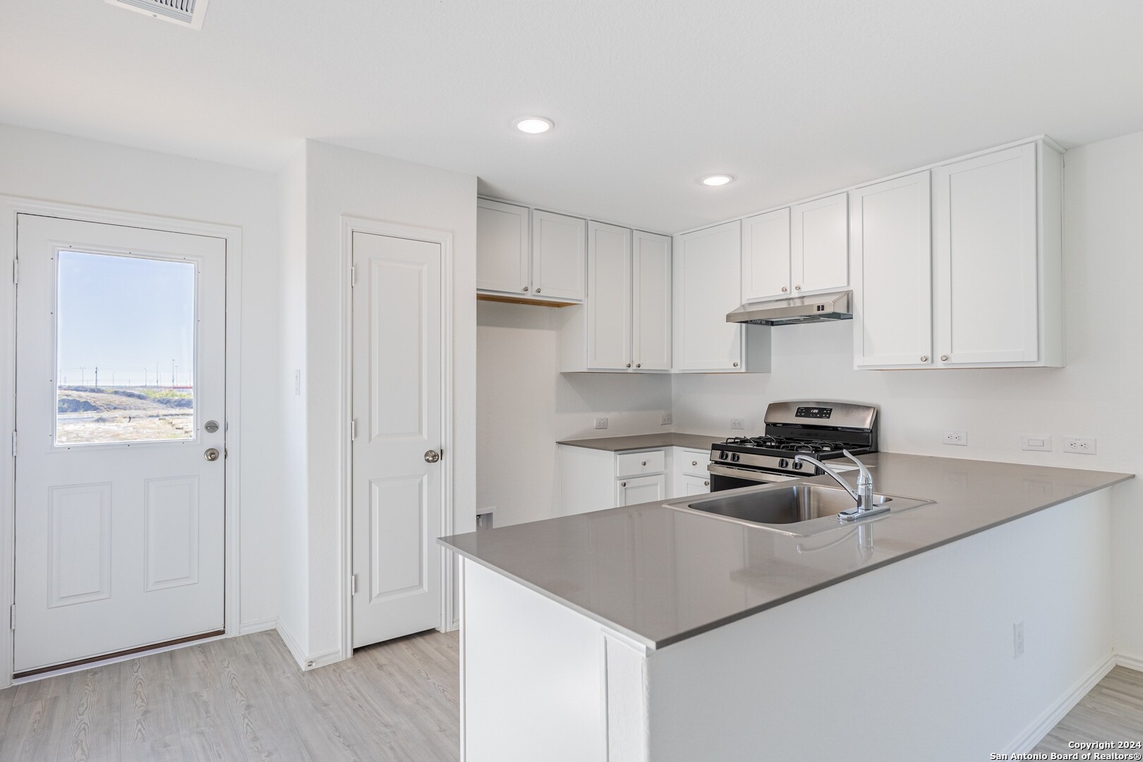 1631 Knoll Ridge New Braunfels, TX 78130 - Photo 8 of 29 a kitchen with stainless steel appliances granite countertop a sink stove and refrigerator