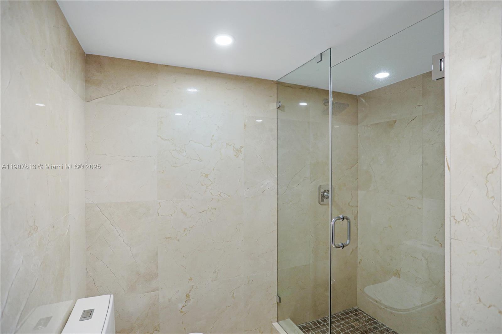 5225 Collins Avenue, Unit 1216 Miami Beach, FL 33140 - Photo 21 of 49 a bathroom with a shower and a toilet