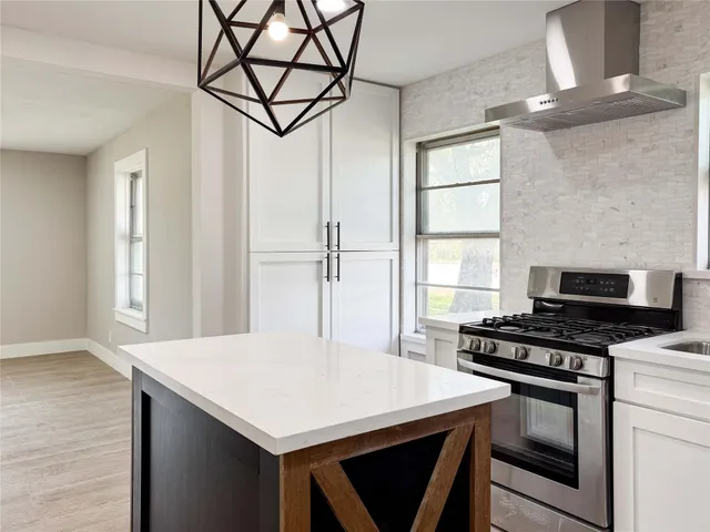 a kitchen with stainless steel appliances a stove a sink and a refrigerator