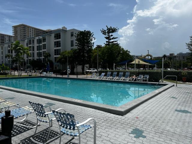 a view of swimming pool with outdoor seating and lake