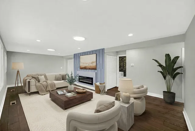 a living room with furniture potted plant and a flat screen tv