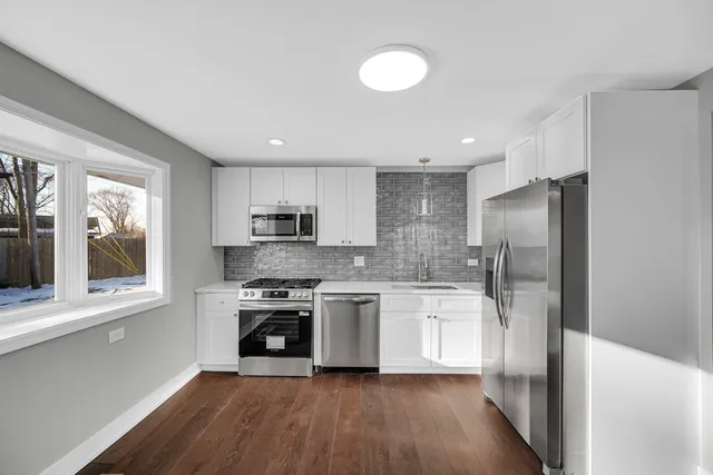 a kitchen with a stove a refrigerator and a sink