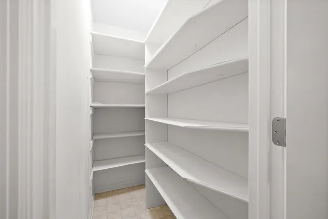 a living room with a floor to ceiling windows and wooden floor