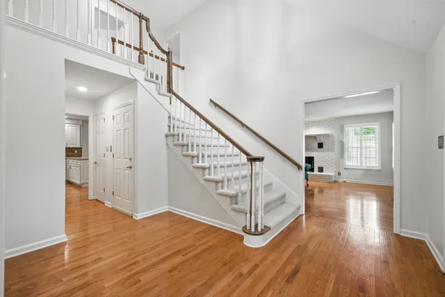 a view of a kitchen with granite countertop cabinets and wooden floor