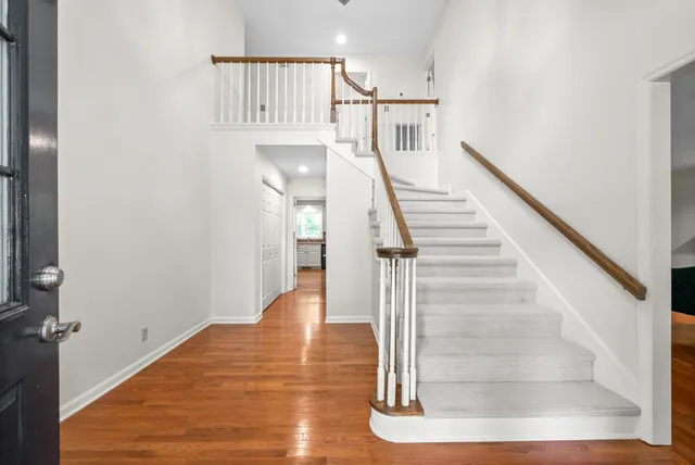 a large kitchen with cabinets and wooden floor