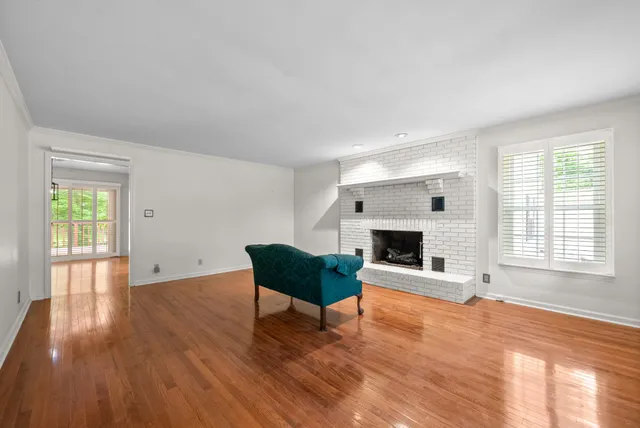 a view of a kitchen counter space with wooden floor and staircase