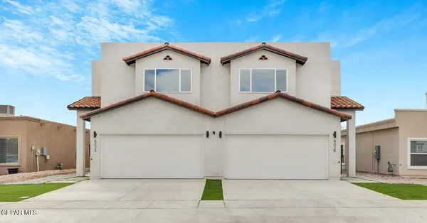 a view of a house with a yard and garage