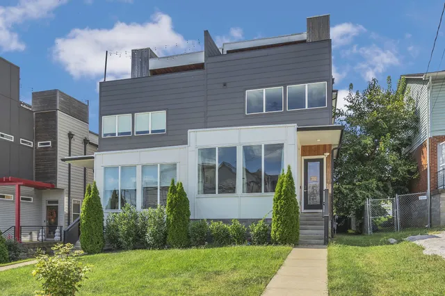 a front view of a house with garden