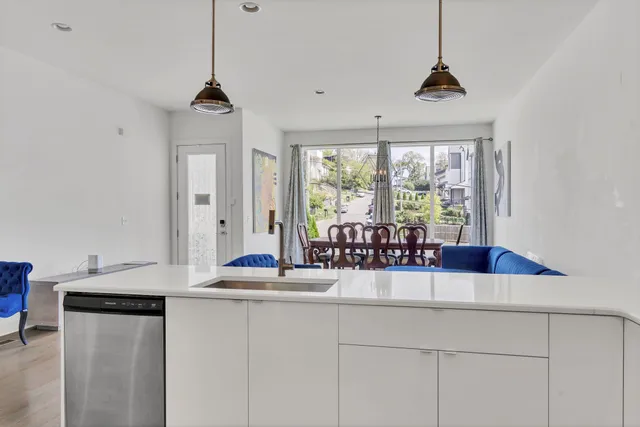 a kitchen with stainless steel appliances granite countertop a sink and a window