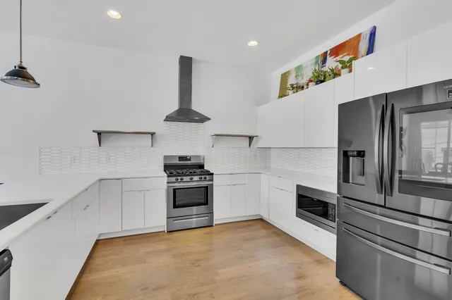 a kitchen with granite countertop a stove and a refrigerator