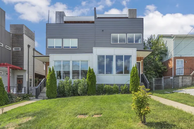 a view of house with a yard and plants