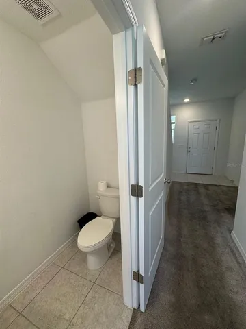 a bathroom with a sink a toilet and mirror