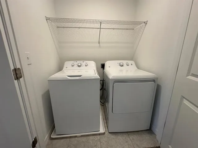 a view of an empty room with a kitchen