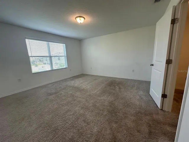 a bathroom with a granite countertop sink and shower