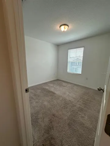 a view of an empty room and closet area