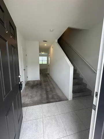 a large kitchen with kitchen island a stove a table and chair