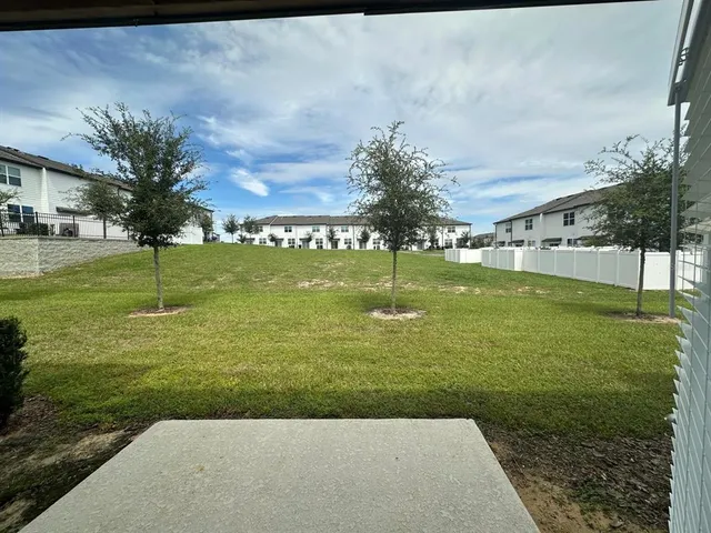 a view of a park with iron fence