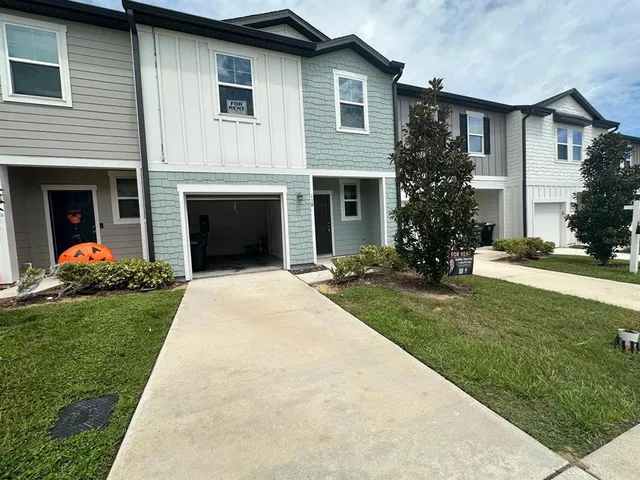 a view of a house with swimming pool and a yard