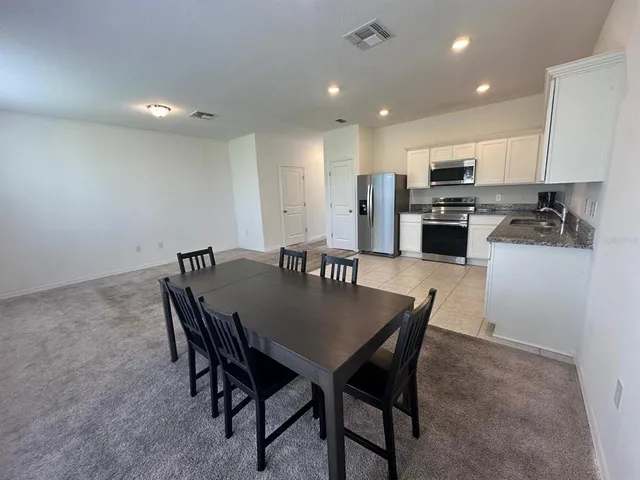 a view of a room with furniture and a window