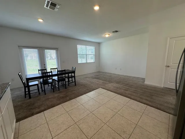 a bathroom with a granite countertop toilet a sink and a mirror
