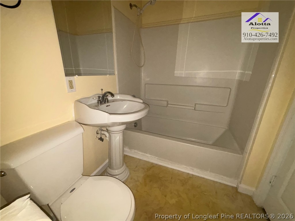 3916 Middle Street Hope Mills, NC 28348 - Photo 11 of 12 a bathroom with a sink a toilet and shower