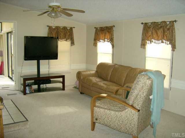 449 Wintergreen Road Timberlake, NC 27583 - Photo 6 of 12 a living room with furniture and a flat screen tv
