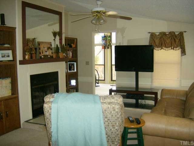 449 Wintergreen Road Timberlake, NC 27583 - Photo 7 of 12 a living room with furniture and a flat screen tv
