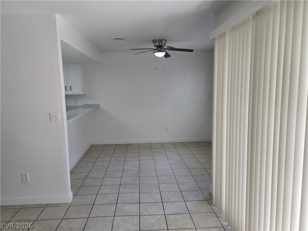 6250 West Flamingo Road, Unit 131 Las Vegas, NV 89103 - Photo 7 of 11 A streamlined dining area featuring an overhead fan and durable tile flooring.