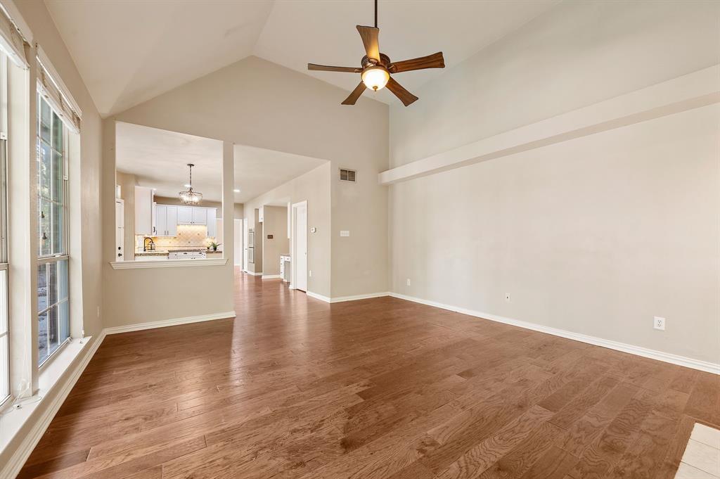 2504 Springhill Drive Grapevine, TX 76051 - Photo 14 of 32 Unfurnished living room with dark wood-style floors, a ceiling fan, and high vaulted ceiling