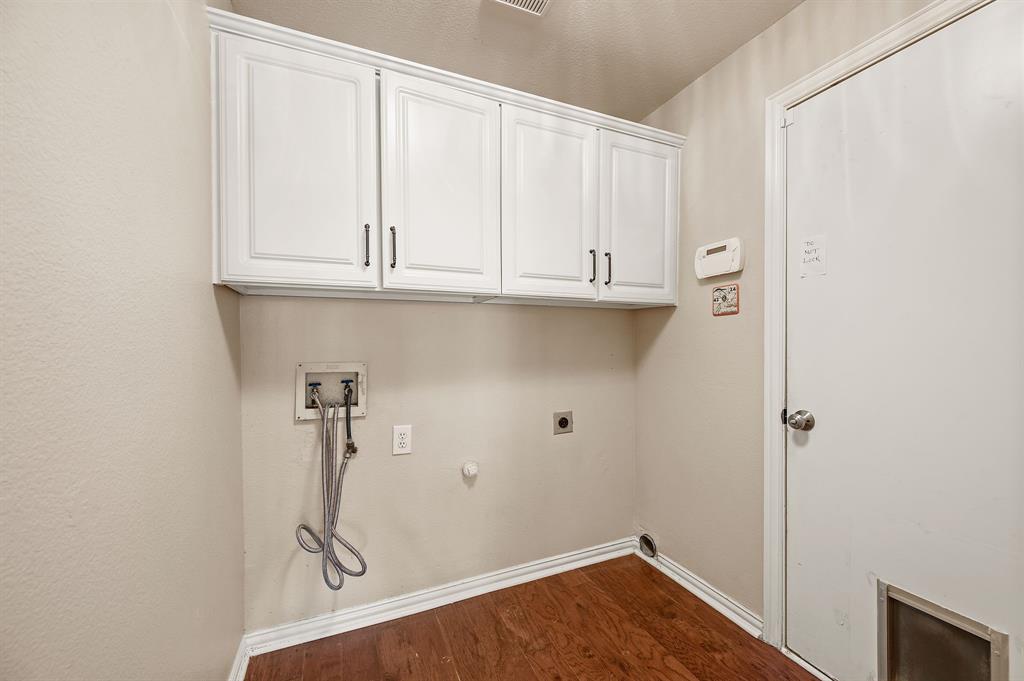 2504 Springhill Drive Grapevine, TX 76051 - Photo 15 of 32 Laundry room featuring gas dryer hookup, electric dryer hookup, cabinet space, washer hookup, and dark wood-type flooring