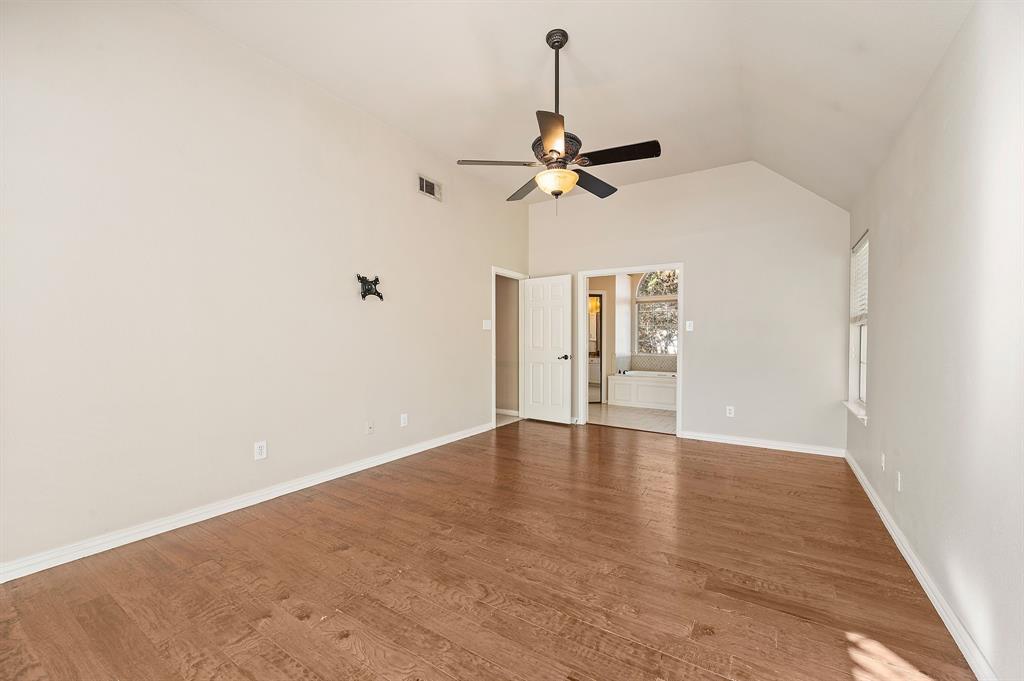 2504 Springhill Drive Grapevine, TX 76051 - Photo 19 of 32 Primary bedroom with vaulted ceiling, light wood-style flooring, and a ceiling fan