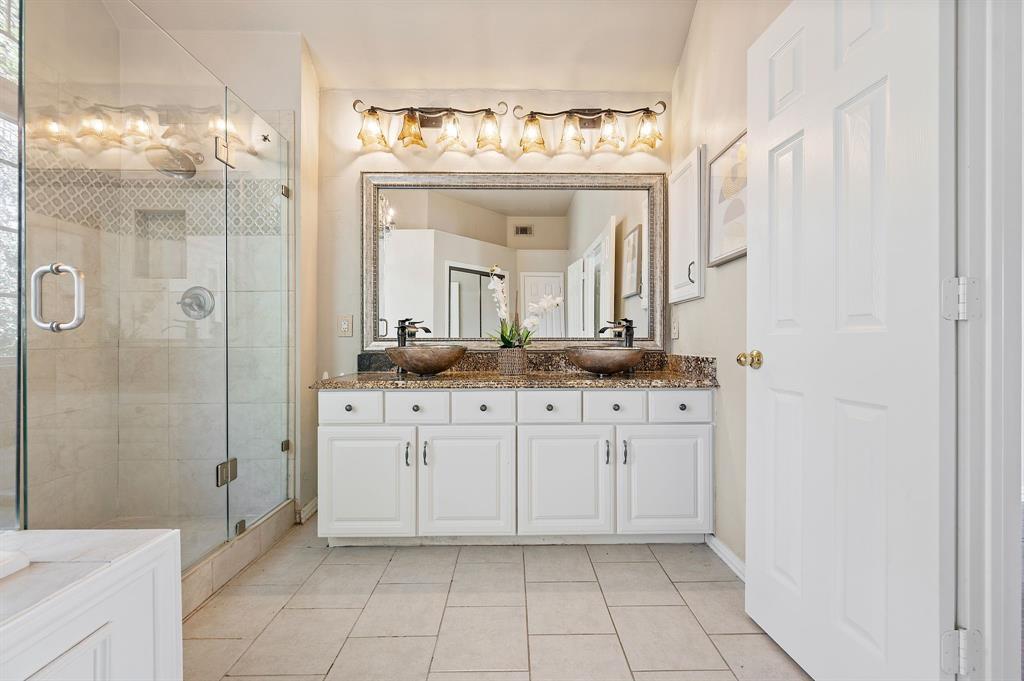 2504 Springhill Drive Grapevine, TX 76051 - Photo 21 of 32 Full bath featuring double vanity, a stall shower, and light tile patterned floors