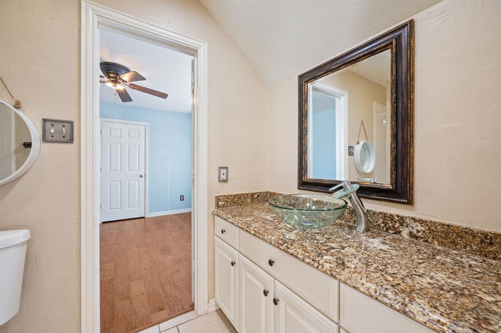 2504 Springhill Drive Grapevine, TX 76051 - Photo 26 of 32 Bathroom featuring vanity, ceiling fan, vaulted ceiling, and light wood-style floors