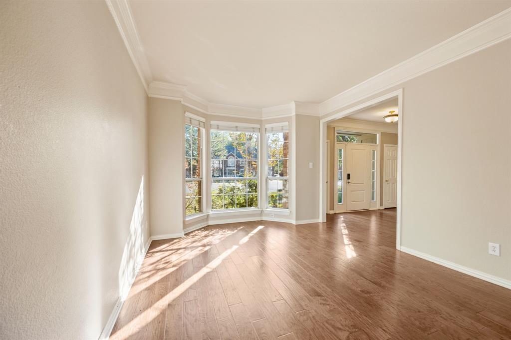 2504 Springhill Drive Grapevine, TX 76051 - Photo 7 of 32 Living room with wood finished floors and crown molding