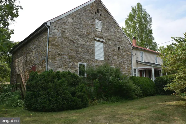 a backyard of a house with plants and tree