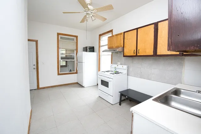 a kitchen with stainless steel appliances a stove a sink and a refrigerator