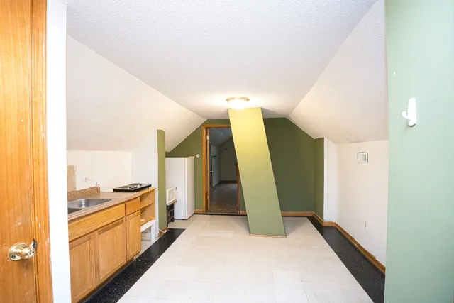 a white toilet sitting next to a bathroom sink and a mirror