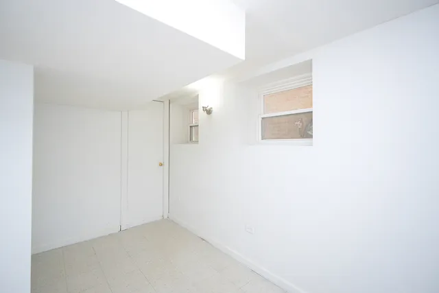 a view of a room with wooden floor and a window